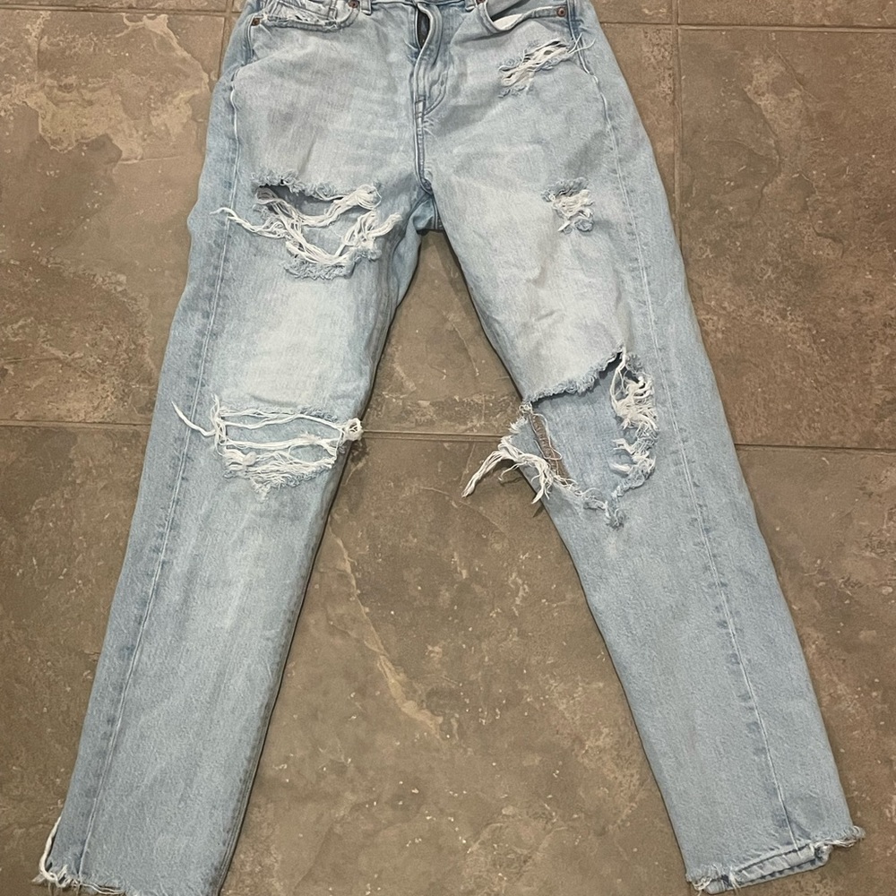 American Eagle ripped mom jeans. I don’t know if they are high wasted or not.
